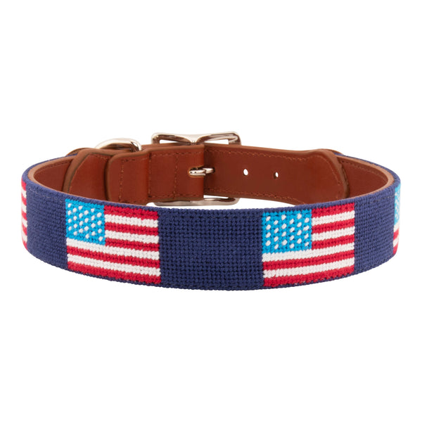 American Flag Needlepoint Dog Collar with navy blue background showing a  repeating pattern of evenly spaced American flags. The dog collar has durable stainless steel and full grain leather backing and strap.