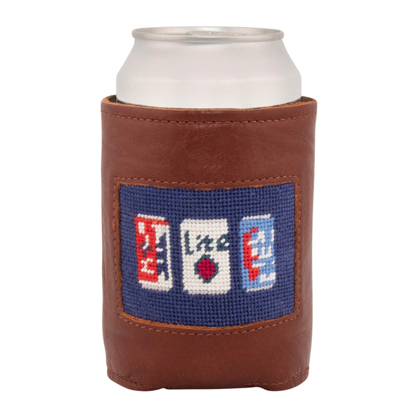 Front face of beer can needlepoint can cooler showing hand-stitched needlepoint beer cans with dark navy blue background. Soft leather body with interior neoprene lining. Great fit for a standard 12 ounce can.