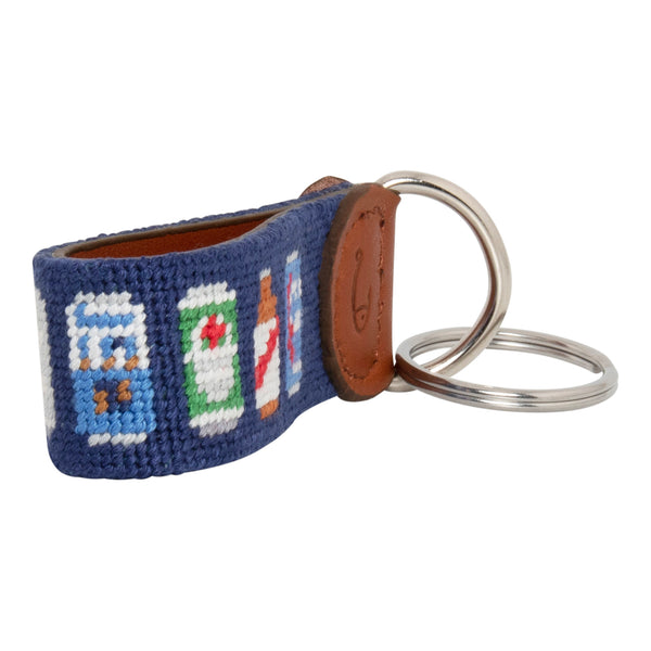 Hand-stitched Beer Can needlepoint keychain showing popular beer can pattern on both sides against a navy blue background and leather backing.  Stainless steel D-ring and keyring.