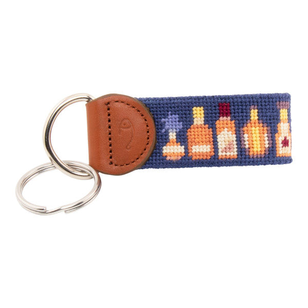 Hand-stitched bluefin tuna needlepoint keychain showing a bluefin tuna on both sides against a light blue background and leather backing.  Stainless steel D-ring and keyring.