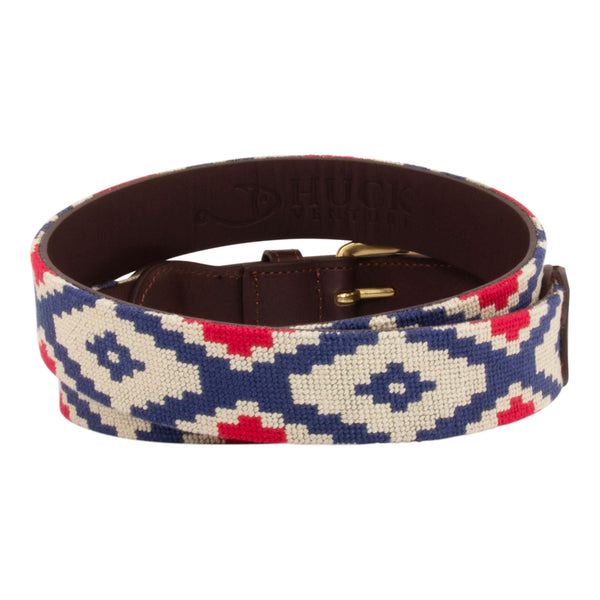 Gaucho Needlepoint Belt showing a gaucho pattern in red white and blue. Belt has a brass buckle and full grain leather backing and strap.