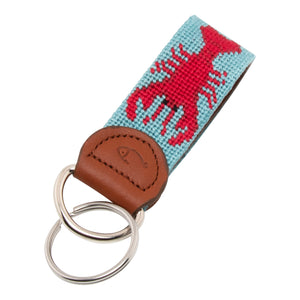 Hand-stitched lobster needlepoint keychain showing a red lobster on both sides against a light blue background and leather backing.  Stainless steel D-ring and keyring.