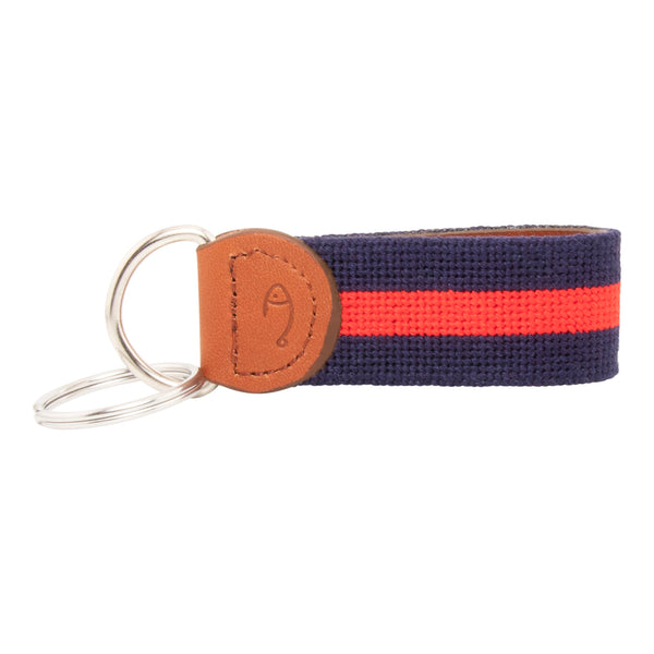 needlepoint keychain with red stripe centered on navy blue background, design wraps around to both sides, hand-stitched, leather background, stainless steel key ring, same design on both sides