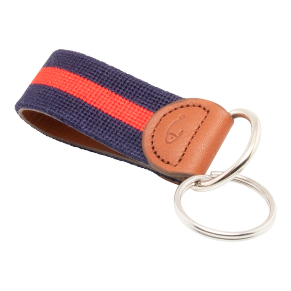 needlepoint keychain with red stripe centered on navy blue background, design wraps around to both sides, hand-stitched, leather background, stainless steel key ring, same design on both sides