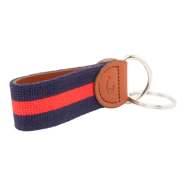 needlepoint keychain with red stripe centered on navy blue background, design wraps around to both sides, hand-stitched, leather background, stainless steel key ring, same design on both sides