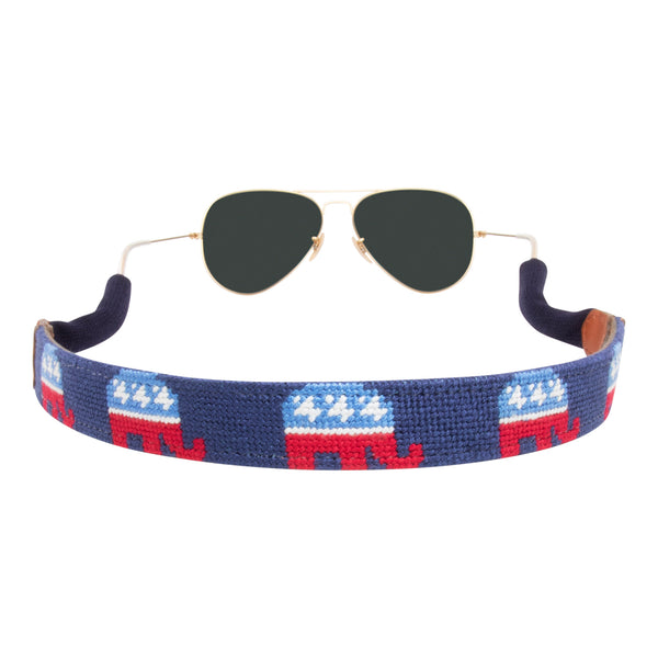 Handmade republican needlepoint sunglass strap showing a republican elephant against a navy blue background with sturdy cotton covered silicone ear connectors and a soft leather backing