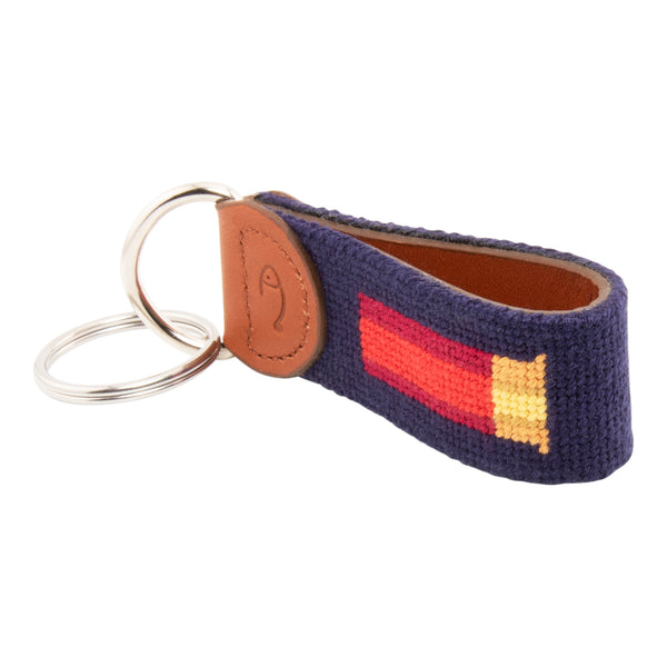 Hand-stitched shotgun shell needlepoint keychain showing a classic red shotgun shell on both sides against a navy blue background and leather backing.  Stainless steel D-ring and keyring.