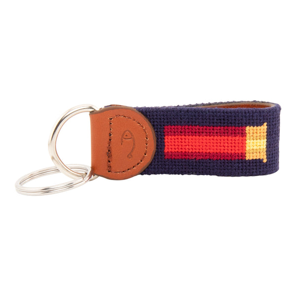 Hand-stitched shotgun shell needlepoint keychain showing a classic red shotgun shell on both sides against a navy blue background and leather backing.  Stainless steel D-ring and keyring.