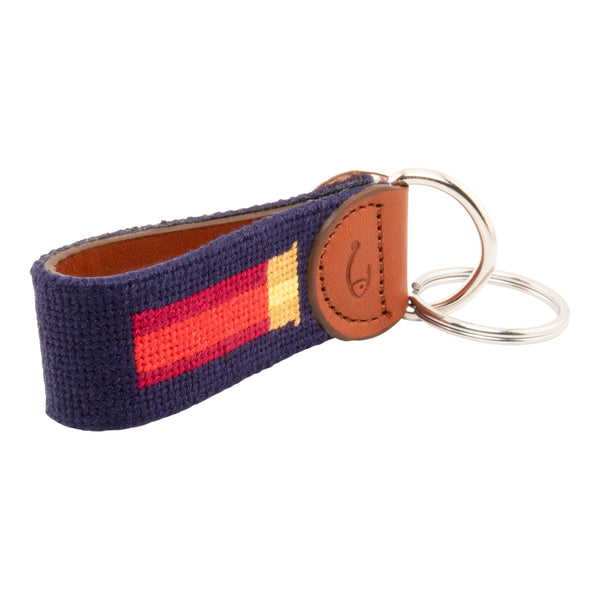 Hand-stitched shotgun shell needlepoint keychain showing a classic red shotgun shell on both sides against a navy blue background and leather backing.  Stainless steel D-ring and keyring.