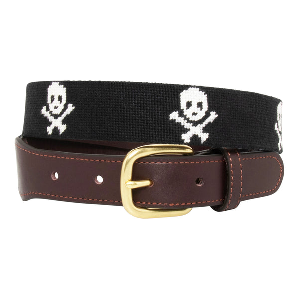 Jolly Roger Needlepoint Belt with black background showing a repeating pattern of evenly spaced white skull and crossbones pattern. Belt has a brass buckle and full grain leather backing and strap.