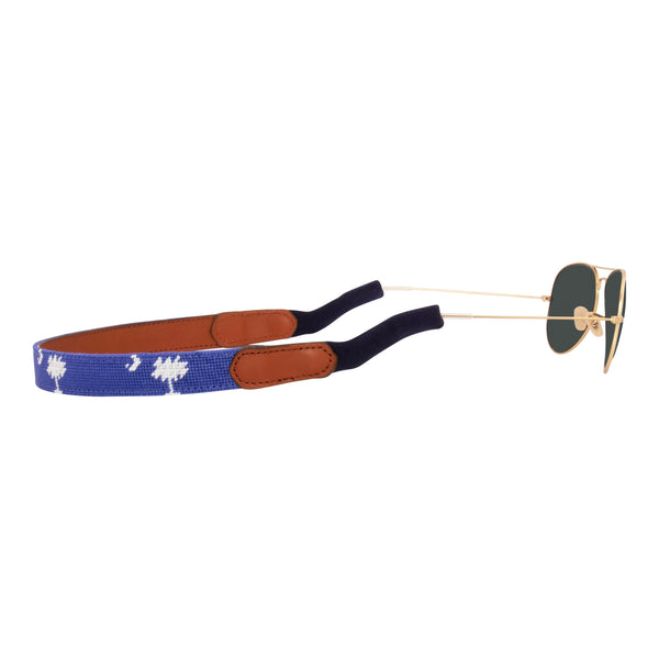 Side View Hand-stitched South Carolina Flag needlepoint sunglass strap showing palmetto and crescent against a blue background with sturdy cotton covered silicone ear connectors and a soft leather backing